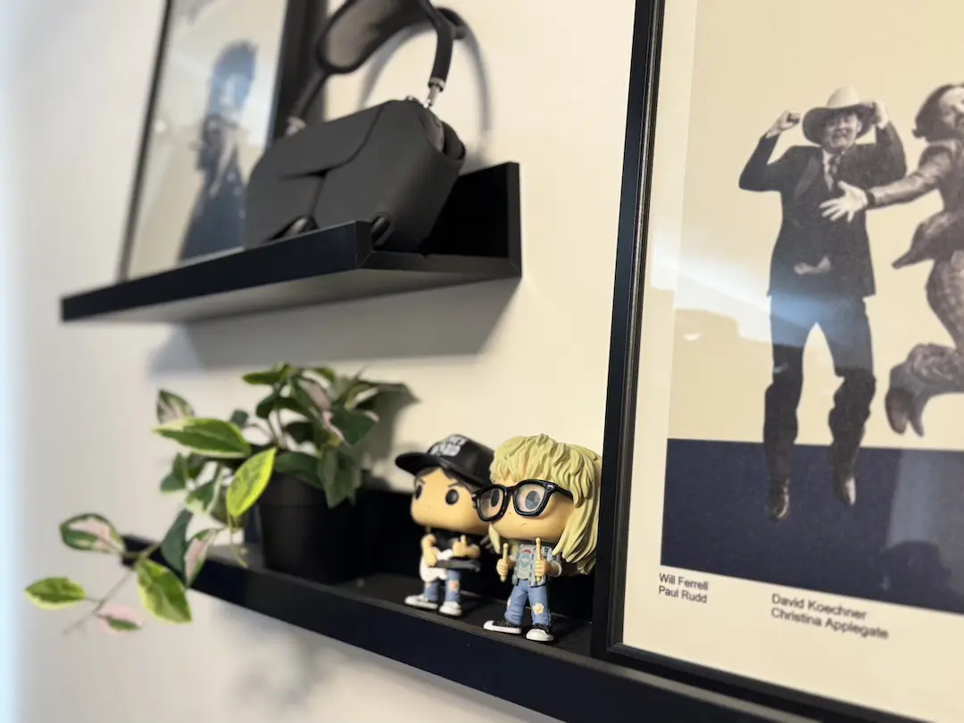 IMG_6494 copy Studio shelves with a VR headset, trailing plant, collectible figures and a framed film poster