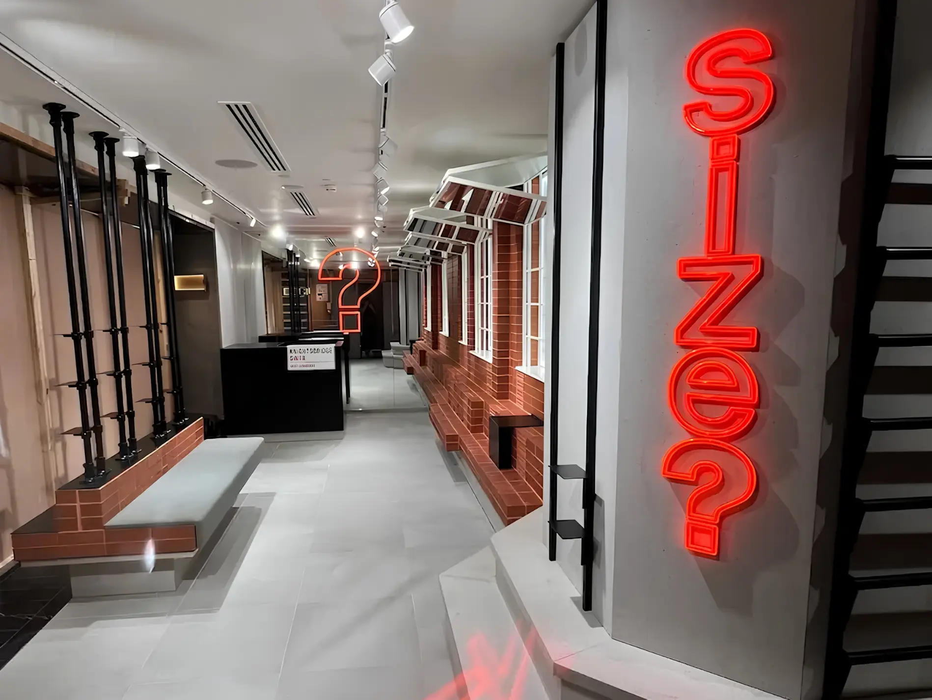 Untitled design (3) Size? store interior with red illuminated signage, brick detailing and display fixtures